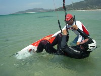Tarifa Max Kitesurfing instructor in the water helping at the waterstart level.